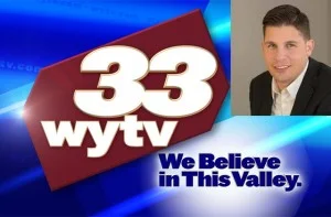 TV news banner showing channel 33 WYTV logo, slogan "We Believe in This Valley," and a photo of a smiling male anchor behind the banner.