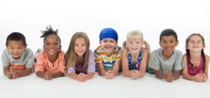 seven smiling children posing for a photo