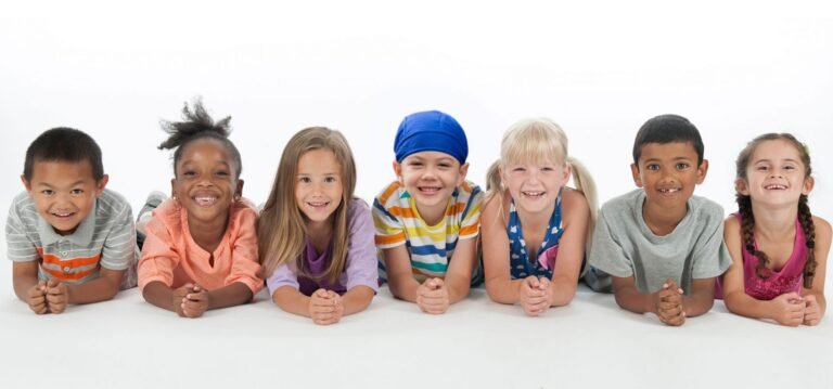 seven smiling children posing for a photo