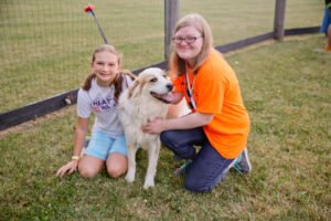 Photo of two girls At A Farm With A Dog