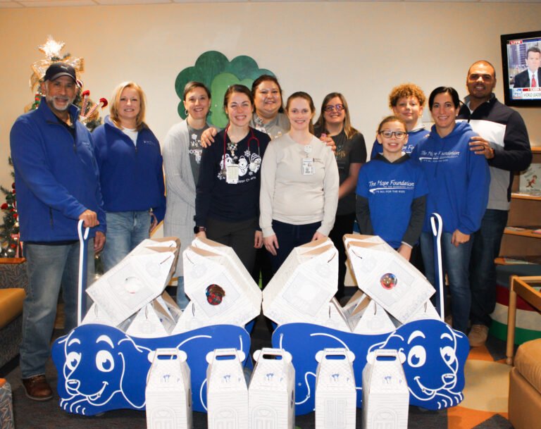 Group photo with donated teddy bears and gift bags for Akron Children's Hospital