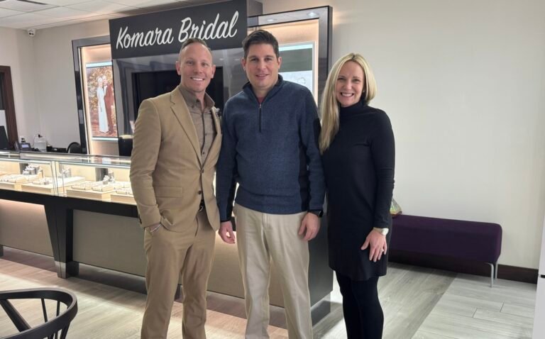 Three people posing together at Komara Jewelers for a Hope Foundation donation